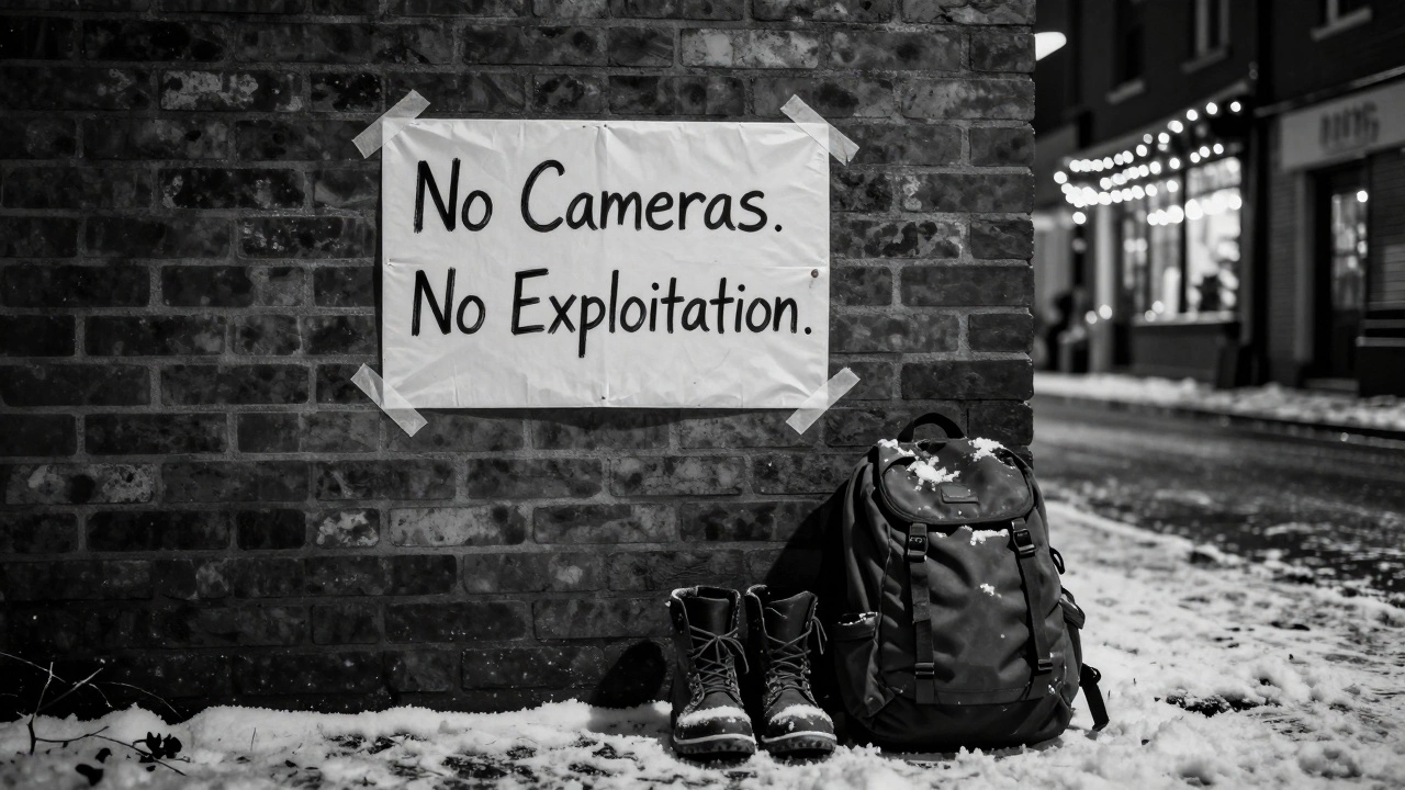 A handwritten sign in an alley reading &#039;No Cameras. No Exploitation,&#039; with boots and backpack beside it.